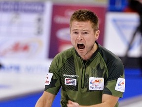 Skip Mike McEwen yells for sweeping against Team Stoughton during draw 13 at the Roar of the Rings Canadian Olympic Curling Trials in Winnipeg, December 5, 2013. (REUTERS/Fred Greenslade)