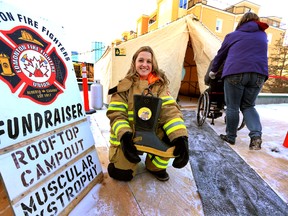 Firefighter Michelle Allan holds a donation boot on the roof of Fire station 2.  Edmonton Fire Fighters will battle Alberta’s unpredictable winter environment to raise funds for Muscular Dystrophy Canada through their 9th annual Rooftop Campout from February 2 - 7, 2014 in Edmonton, Alta., on Sunday Feb 2, 2014. Perry Mah/Edmonton Sun/QMI Agency