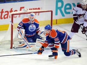 Jan 24, 2014; Edmonton, Alberta, CAN; Edmonton Oilers defenseman Martin Marincin (85) tries to stop a shot on goalie Ilya Bryzgalov (80) during the game against the Phoenix Coyotes at Rexall Place. Mandatory Credit: Candice Ward-USA TODAY Sports