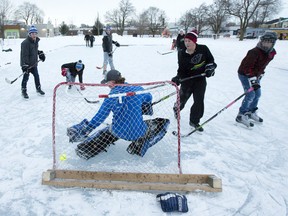 Noah Meldrum takes a shot on goalie Alton Howard as they play hockey on an outdoor rink at the Boyle Community Centre in the Old East Village in London. Spearheaded by members of the Boyle Activity Council, the rink is open to anyone who wishes to use it.