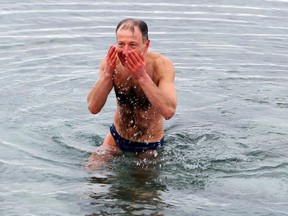 Natan Gendelman takes a dip Sunday at Colonel Samuel Smith Park in Etobicoke. (VERONICA HENRI, Toronto Sun)