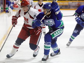 Sudbury Nickel Barons defenceman Khadyn Butterfly tries to halt rushing North Bay Jr. Trappers defenceman Zachary Shankar during the Barons' 1-0 win at West Ferris Community Centre last season. JORDAN ERCIT/QMI Agency