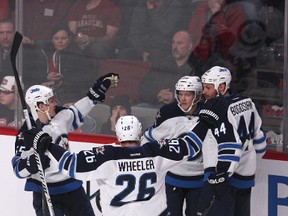 Feb 2, 2014; Montreal, Quebec, CAN; Winnipeg Jets defenceman Tobias Enstrom (39) celebrates his goal against Montreal Canadiens with teammates right wing Blake Wheeler (26) and defenceman Zach Bogosian (44) and center Mark Scheifele (55) during the second period at Bell Centre. Mandatory Credit: Jean-Yves Ahern-USA TODAY Sports