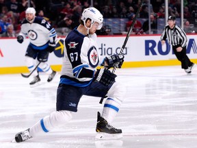 Michael Frolik celebrates his third-period game-winning goal during the NHL game against the Montreal Canadiens at the Bell Centre on Feb. 2, 2014 in Montreal, Quebec, Canada. The Jets defeated the Canadiens 2-1. (Richard Wolowicz/Getty Images/AFP)