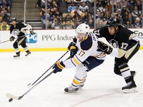 n 27, 2014; Pittsburgh, PA, USA; Buffalo Sabres left wing Linus Omark (17) tries to skate away from Pittsburgh Penguins left wing Taylor Pyatt (17) during the third period at Consol Energy Center. Penguins beat the Sabres 3-0. Mandatory Credit: Raj Mehta-USA TODAY Sports