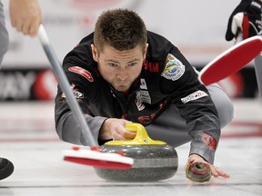 Skip Mike McEwen delivers a rock during the Safeway Select men's curling final in Winnipeg, Man. Sunday February 02, 2014.
Brian Donogh/Winnipeg Sun/QMI Agency