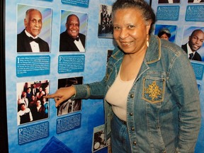Phyllis Brown, a volunteer at the Mosaic Templars Cultural Centre in Little Rock, points to a picture of sister Minijean, one of the Little Rock Nine at the centre's Arkansas Black Hall of Fame. WAYNE NEWTON PHOTO