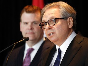 John Baird, minister of foreign affairs, looks on from the background as Dr. Mark Kristmanson, incoming National Capital Commission (NCC) CEO, speaks to the media at the Lester B. Pearson building in Ottawa on Monday Feb. 3, 2014. 
Darren Brown/Ottawa Sun/QMI Agency