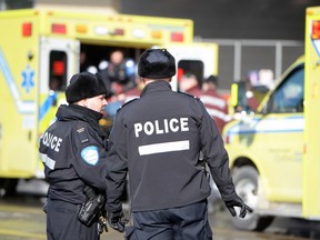 Rescuers come to the aid of a man who was shot by police Feb. 3, 2014, at the intersection of Berri and Ontario in Montreal.
MAXIME DELAND / QMI AGENCY