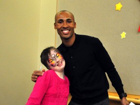 Brigitte Fox poses for a photo with Canadian decathlete Damian Warner at the London Convention Centre Feb.3, 2014. Warner was one of the guests at the 2014 Rogers Sports Celebrity Dinner, a major annual fundraiser for the local Thames Valley Children’s Centre.