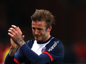 Paris Saint-Germain's David Beckham breaks down in tears as he leaves the pitch during his team's French Ligue 1 match against Brest at the Parc des Princes stadium in Paris May 18, 2013. (REUTERS/Gonzalo Fuentes)