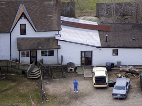 OPP Forensics officers sift through areas on the Kellestine farm on Aberdeen Rd near Cowan just north of Iona Station after a massacre that left eight members of the Bandidos motorcycle gang dead. (Postmedia Network file photo)