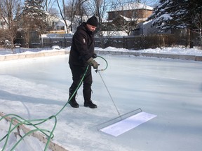 Kevin McDermott applies water to his Kingston backyard rink with his Manzoni tool.
Ian MacAlpine/The Whig-Standard