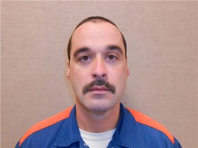 Michael David Elliot, 40, shown in this Michigan Department of Corrections photo, escaped from Ionia Correctional Facility in Ionia, Michigan on February 2, 2014. Michael David Elliot who was sentenced to life in prison in Michigan for murdering four people in 1993, has escaped and is on the loose after kidnapping a woman and forcing her to drive to Indiana, according to prison authorities and media reports.  REUTERS/Michigan Department of Corrections/Handout