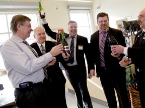 Prince Edward County Mayor Peter Mertens opens a bottle of Barley Days Brewery beer toasting the grand opening of the new LCBO store in Rossmore Tuesday, Feb 4, 2014. Also shown are, from left, senior vice president of retail operations Bob Clevely, store manager Paul Lavender, eastern regional director Mark Mason and district manager Gus Loukas. 
Emily Mountney/QMI Agency