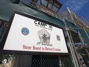 A guard opens the gate at the entrance to Camp VI, a prison used to house detainees at the U.S. Naval Base at Guantanamo Bay, in this March 5, 2013, file photo. (REUTERS/Bob Strong/Files)