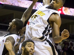 London Lightning player Marvin Phillips comes down on top of Mississauga Power player Dwight McCombs as they look to recover a rebound during their NBL Canada basketball game at Budweiser Gardens in London, Ont. on Sunday November 17, 2013. (QMI Agency file photo)