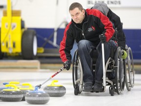 Curler Mark Ideson, who will represent Canada at the Paralympics in Sochi, Russia, practices throwing rocks down the sheet at the Ilderton Curling Club as he prepares for competition in Ilderton, Ontario on Tuesday February 4, 2014. (CRAIG GLOVER, The London Free Press)