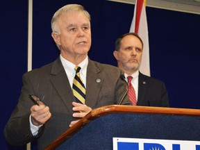 Florida Department of Law Enforcement Commissioner Gerald Bailey, with Assistant FDLE Commissioner Jim Madden (R), announces an investigation into evidence tampering that could affect hundreds of drug cases handled by a chemist in the Pensacola FDLE laboratory during a news conference in Tallahassee, Florida, February 1, 2014.(REUTERS/Bill Cotterell)