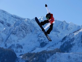 Canadian snowboarder Mark McMorris spins off a jump during slopestyle snowboard training at the 2014 Sochi Winter Olympics in Rosa Khutor February 4, 2014.    REUTERS/Mike Blake