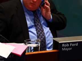 Mayor Rob Ford speaks on a cellphone during a council meeting in City Hall this November 2013 file photo. (DAVE ABEL/Toronto Sun)