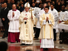 Pope Francis leaves at the end of a mass in Saint Peter's Basilica at the Vatican February 2, 2014. REUTERS/Tony Gentile