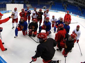 Head coach of Russian national women's ice hockey team Mikhail Chekanov instructs players during their team's training session at the Shayba Arena in preparation for the 2014 Sochi Winter Olympics, in Sochi February 3, 2014. The women's ice hockey competition begins on February 8. REUTERS/Grigory Dukor