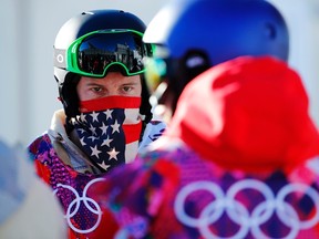 U.S. snowboarder Shaun White waits in line during a breakdown of the chairlift at snowboard slopestyle training for the 2014 Sochi Winter Olympics in Rosa Khutor, February 3, 2014.    REUTERS/Mike Blake