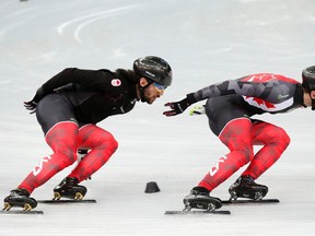 Charles Hamelin, left, and his brother, Francois, skate together in preparation for the 2014 Sochi Winter Olympics at the Iceberg Skating Palace on Tuesday. (Reuters)