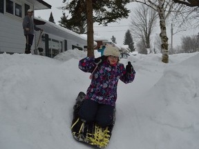 Mia Smit slides down a 50-foot luge built by her dad, Mike, on the front lawn of the family's home in Orillia.