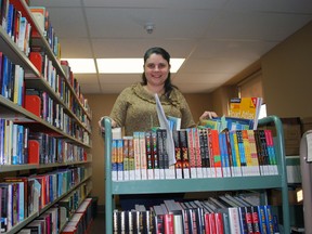 Elgin County Library coordinator Sandi Loponen stands next to a book shelf and behind a book cart at the county office on Sunset Dr. near St. Thomas. Loponen will spend the next year as vice-president of the Ontario Public Library Association and take over as president in 2015.
