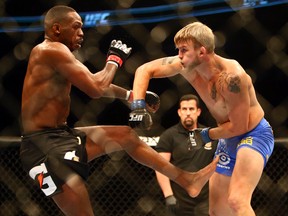 Jon Jones (red) defeats Alexander Gustafsson (blue) during the light heavyweight championship bout during UFC 165 at the Air Canada Centre in Toronto on September 22, 2013. (Dave Abel/Toronto Sun/QMI Agency)