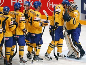 Sweden's goalkeeper Jhonas Enroth is congratulated by Victor Hedman  and other teammates after winning their 2012 IIHF mens's ice hockey World Championship Group S game with Norway in Stockholm May 4, 2012. (REUTERS/Petr Josek)