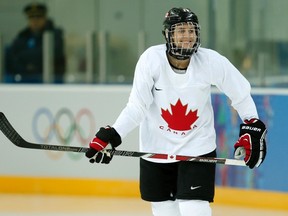 Canadian women's hockey team alternate captain and flag bearer Hayley Wickenheiser laughs during their practice ahead of the 2014 Sochi Winter Olympics February 4, 2014. (REUTERS/Mark Blinch)