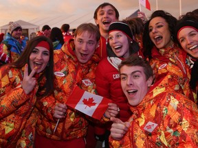 Canadian athletes pose for photos with Russian athletes during the Canadian flag-raising ceremony at the Olympics in Sochi on Wednesday, February 5, 2014. (AL CHAREST/QMI Agency)