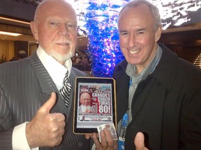Don Cherry and Ron MacLean hold the cover of Wednesday's Toronto Sun marking Grapes's 80th birthday in Sochi, Russia. (Supplied photo)