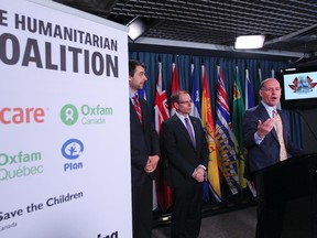 Robert Fox with Oxfam Canada speaks along side Kevin McCort, centre, with Care Canada and Nicolas Moyer with the Humanitarian Coalition speak to the media in Ottawa in this May 14, 2013 file photo. The Humanitarian Coalition and its member agencies spoke to the media regarding the plight of Syrian civilians, both inside Syria and in neighbouring countries. (Andre Forget/QMI Agency)