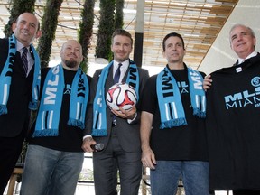 Former England and Manchester United star, David Beckham poses for photos after holding a press conference at the Perez Art Museum Miami, in Miami, Florida on February 5, 2014. (AFP PHOTO / Alexia Fodere)