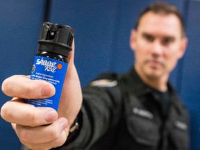 Ottawa PDC instructor Const. Martin displaying a pepper spray canister during a media "show and tell" session on Dec. 4, 2013 that presented information about Use of Force training at the Ottawa Police Service Professional Development Centre. (Errol McGihon/Ottawa Sun/QMI Agency)