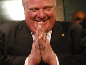 Mayor Rob Ford laughs about his admission that he's broken the law a lot of times — in reference to jay-walking — as he speaks to the media at Toronto City Hall Wednesday, February 5, 2014. (Stan Behal/Toronto Sun)