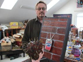 Artist Norman Barney shows off "Pepsi Generation #1" at his Petrolia studio. His mixed media art will be the focus of a new exhibit "Curiouser & Curiouser" set to launch at the Judith & Norman Alix Art Gallery this Friday. BARBARA SIMPSON/THE OBSERVER/QMI AGENCY