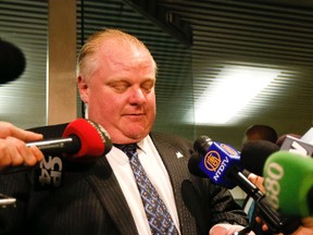 Toronto Mayor Rob Ford shows reporters his BlackBerry — but says he won't give it to Toronto Police without a warrant — Wednesday, February 5, 2014. (Stan Behal/Toronto Sun)