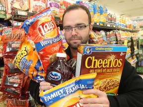 Colin Craig of the Canadian Taxpayers Federation displays foods that could be subject to a "fat tax." (Brian Donogh/Winnipeg Sun)