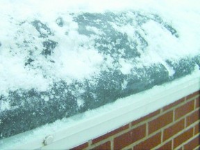 Ice damming on the lower edge of the roof or gutters of a house can cause moisture to back up into the shingles, the attic or the house itself. (Special to the Free Press)