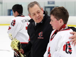 Former hockey coach Ted Hay is being honoured with a hockey rink in his name. Hay died at age 54 in 2011. On Saturday, Feb. 8, 2014 the outdoor rink at South Nepean Park will bear his name.  Coach Hay is shown here with the Major Bantam "B" team in November 2010 after winning a tournament in Toronto. (Submitted photo)