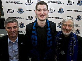 FC Edmonton manager Colin Miller (left) and owner Tom Fath (right) flank the team’s new addition, defender Marko Aleksic, at St. Joseph school on Wednesday Feb. 5, 2014. Codie McLachlan/QMI Agency.
