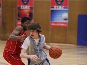 Sacre Coeur's Justin Lamontange gets past a Macdonald-Cartier defender during junior boys Division II play at Macdonald-Cartier on Tuesday night. GINO DONATO/THE SUDBURY STAR