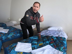 Canada's Chef de Mission Steve Podborski hams it up for the cameras in a room where Canadian NHL players will stay while competing at the 2014 Winter Olympics in Sochi, Russia, Feb. 4, 2014. (AL CHAREST/QMI Agency)