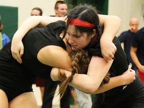 Victoria Porter (right) of Bayside grapples with Moira's Meagan Baranyai during the Charger Invitational wrestling meet Thursday at Centennial. Baranyai won the match. (PAUL SVOBODA/The Intelligencer)