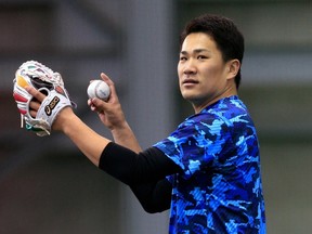 Japanese pitcher Masahiro Tanaka gets set to throw during a training session in Sendai, Japan on January 23, 2014. (AFP PHOTO / JIJI PRESS)
